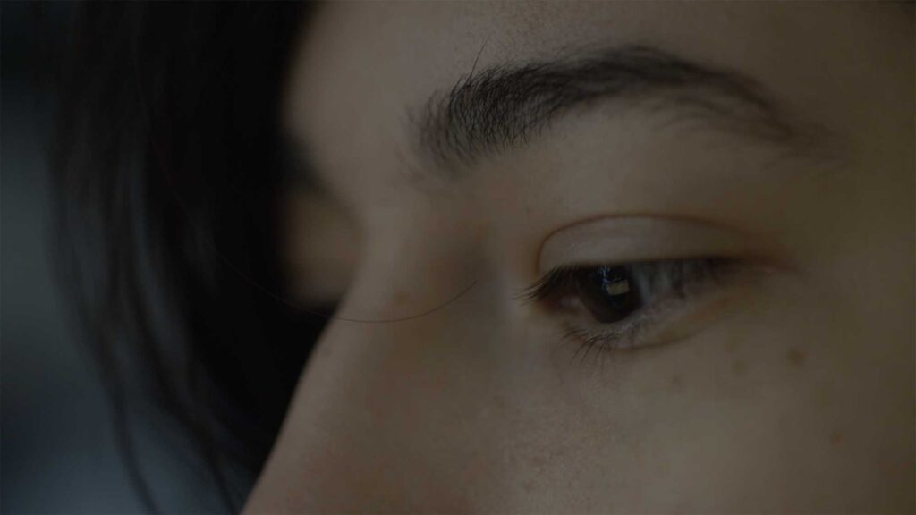 Close-up of eyes of Minerva University student in Seoul, South Korea, as she collaborates with internship employee on project.