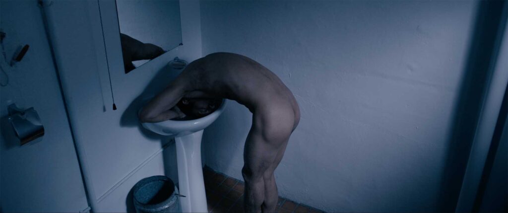 Kwang Lee, an ethnic Korean Chinese homeless immigrant in Seoul, cleans himself naked in a public bathroom sink, stripped to his bare bones.