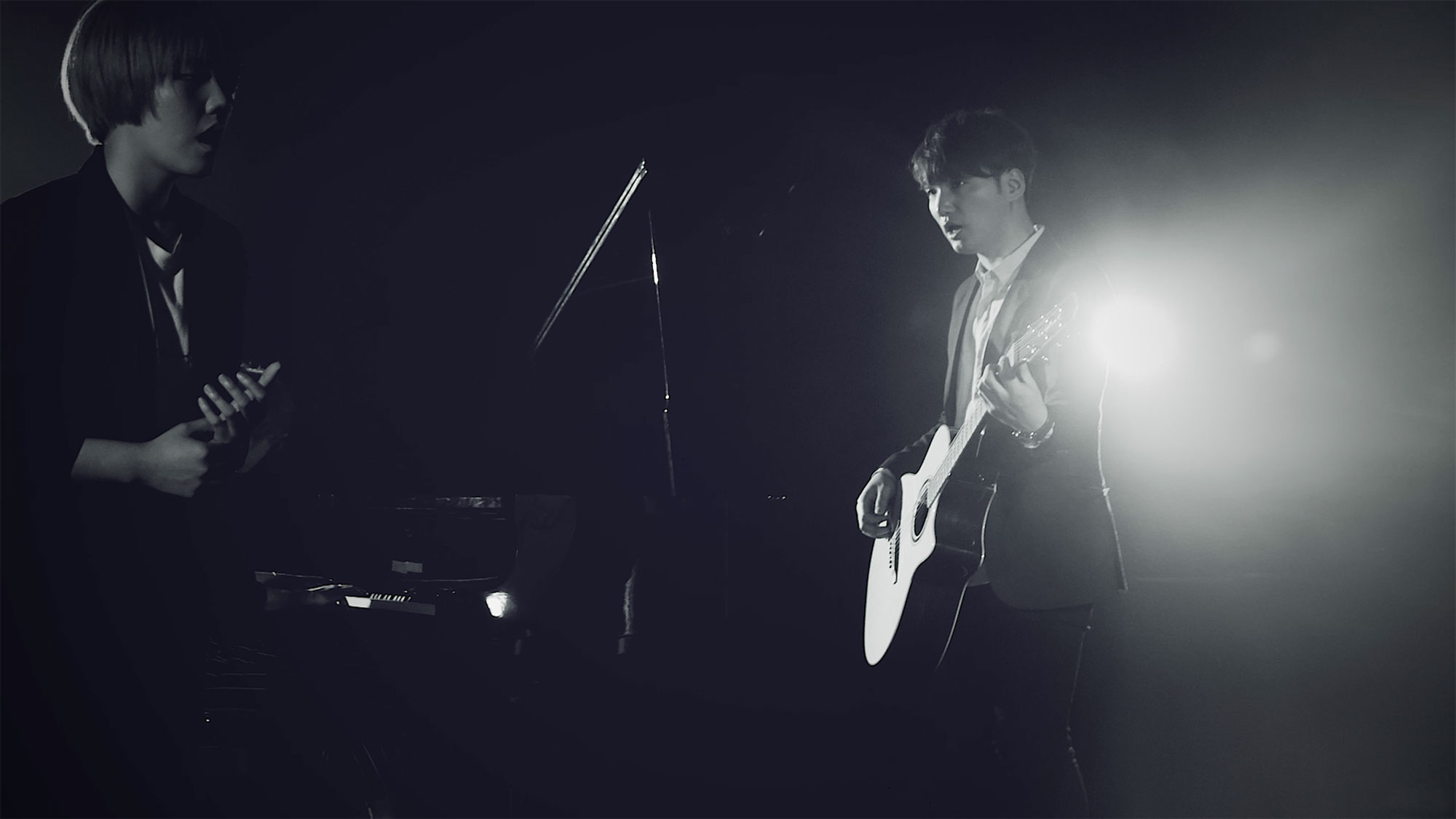 Korean singer and guitarist performing on stage in Seoul, South Korea, for music video "Beautiful Woman" from Tune-Up Joong-Hyun Shin: Origin tribute album.