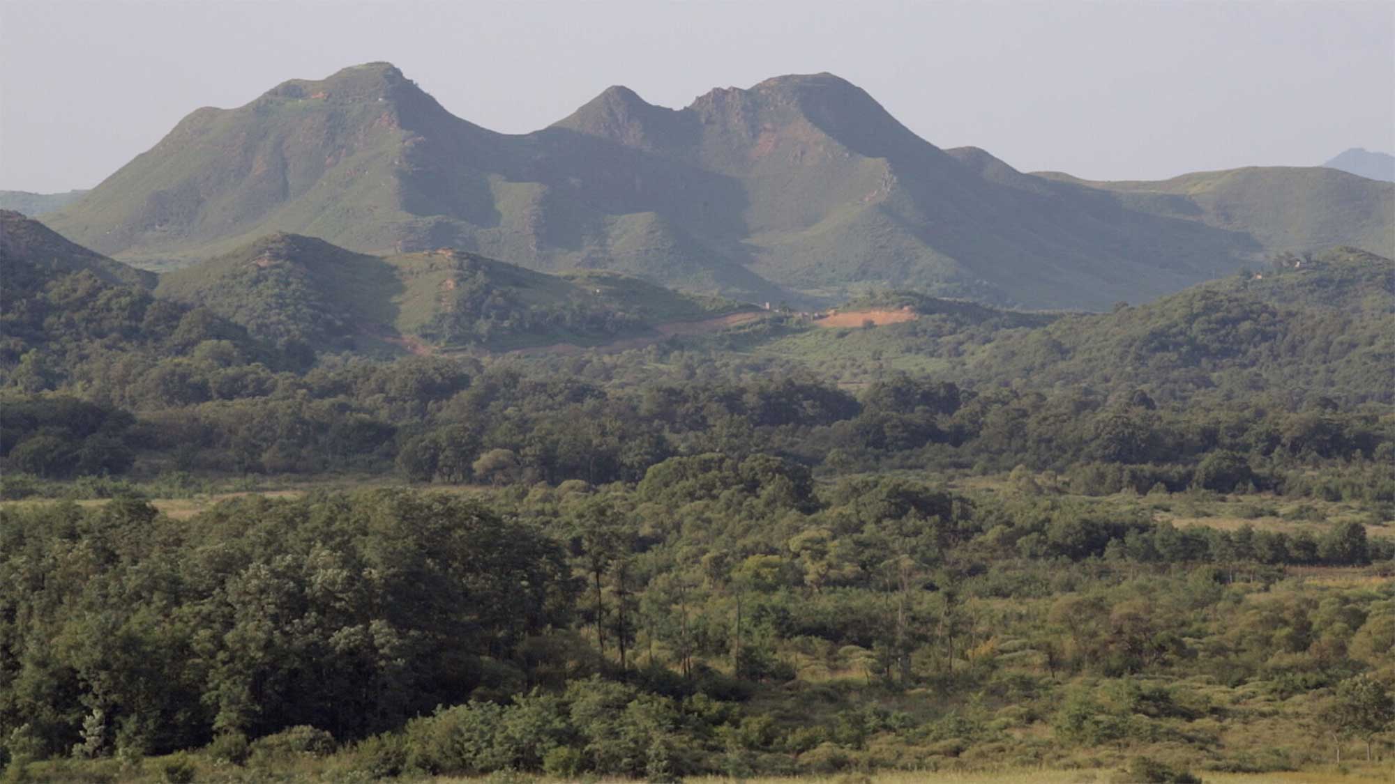 Mountain landscape overlooking DMZ near small village Yangjiri, Cherwon, Kangwando Province, facing North Korean territory in short film ART ATTACK.