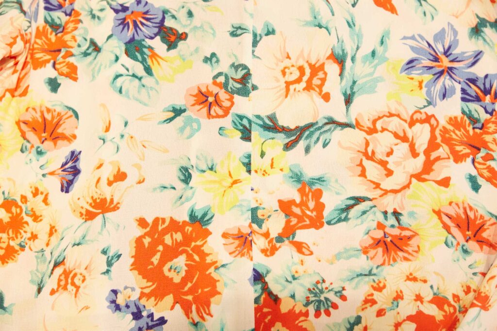 A vibrant flower-patterned wallpaper featuring rich tones of red, yellow, green, purple, and brown, displayed in a store in Seoul, South Korea.