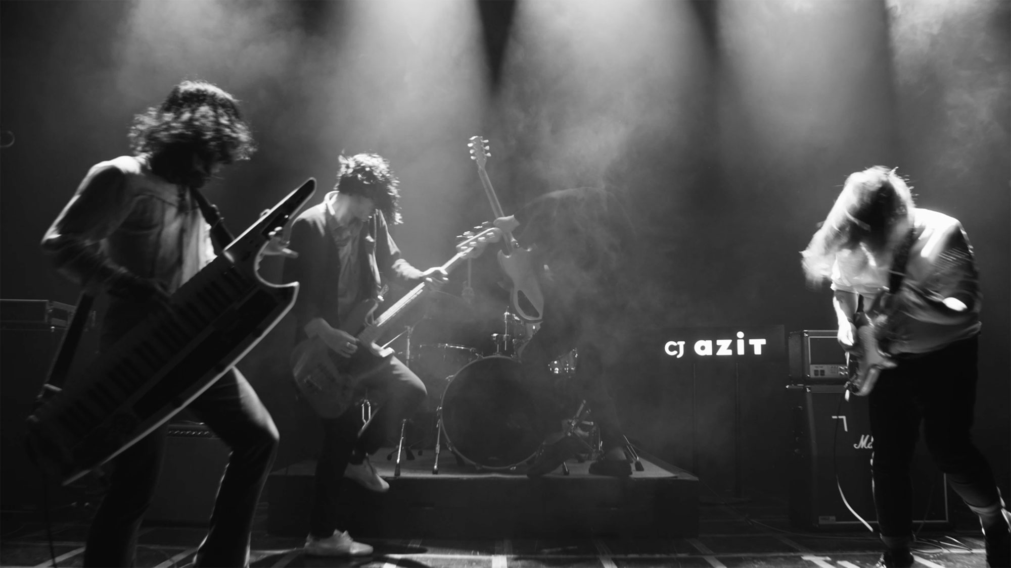 Young Korean band on stage giving wild performance in Seoul, South Korea, for music video "Beautiful Woman" from Tune-Up Joong-Hyun Shin: Origin tribute album.