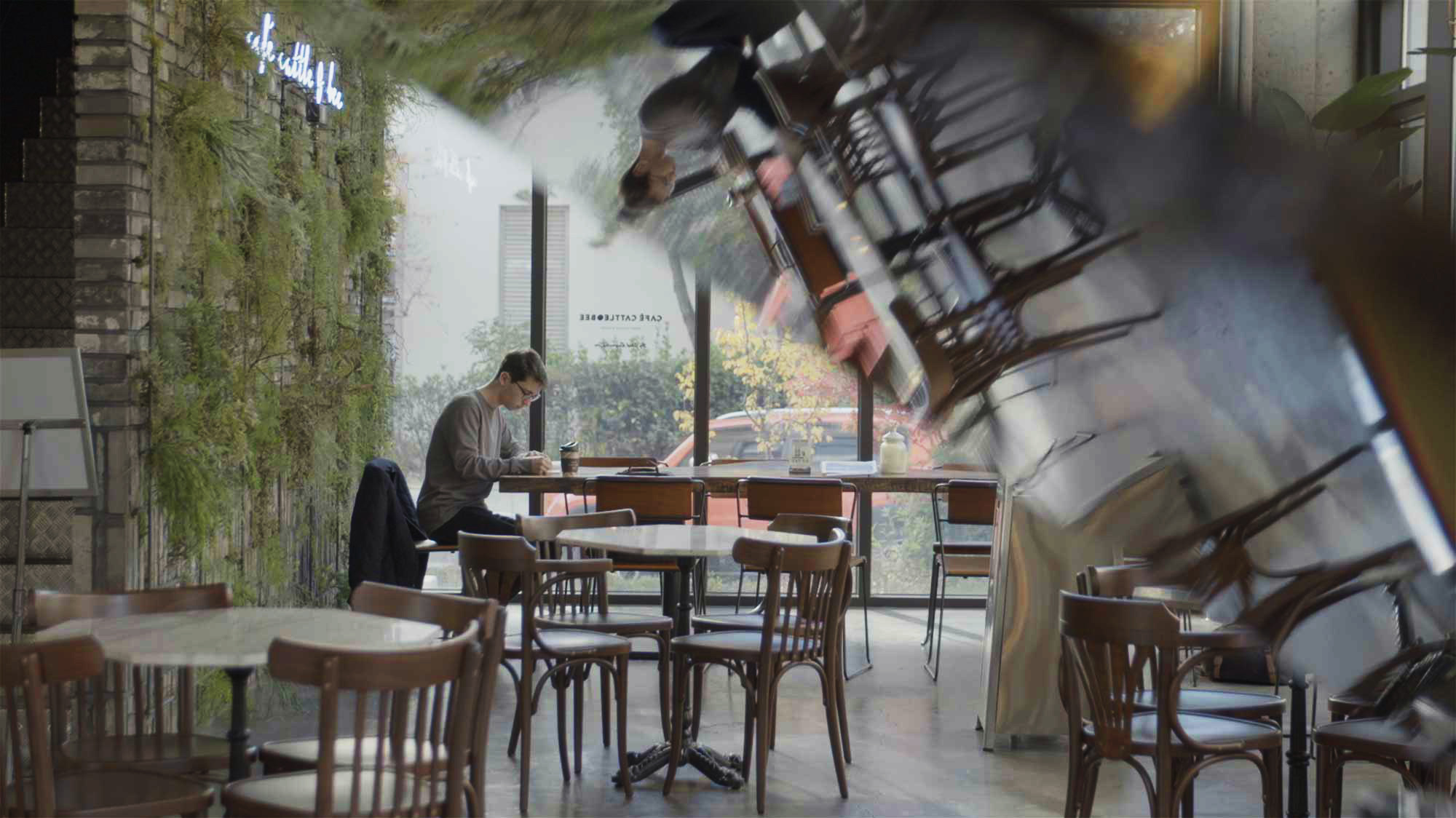 Minerva University student sits in favorite cafe in Seoul, South Korea, working on drawings for school.