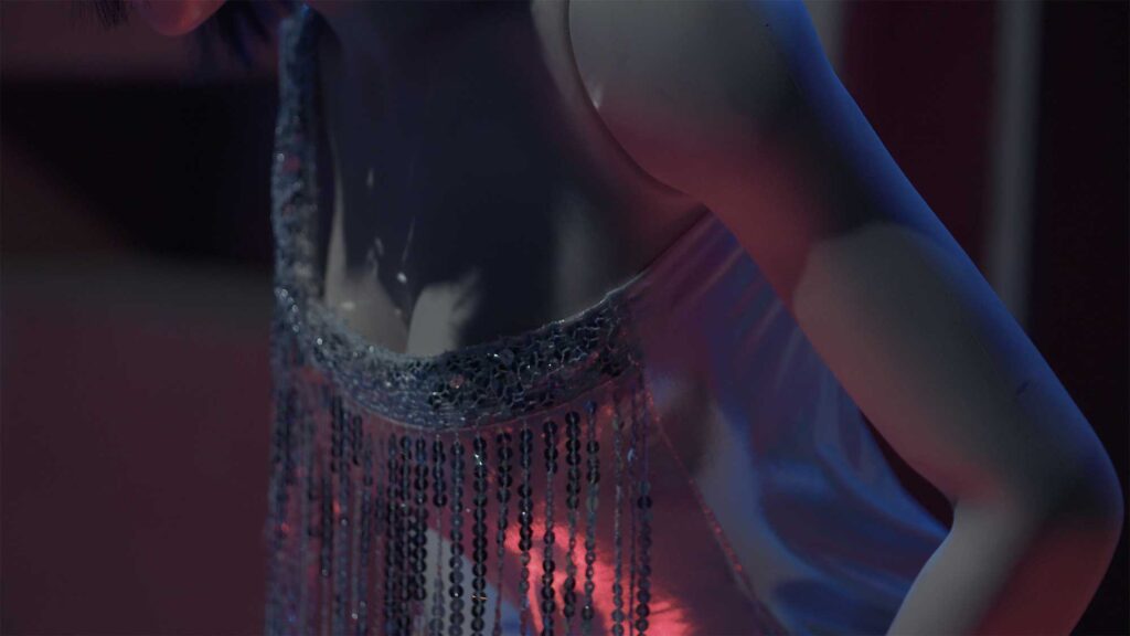 Close-up of deep décolleté of plastic doll with human traits wearing a fancy cocktail dress as part of film Plastic Girls in Seoul, South Korea.