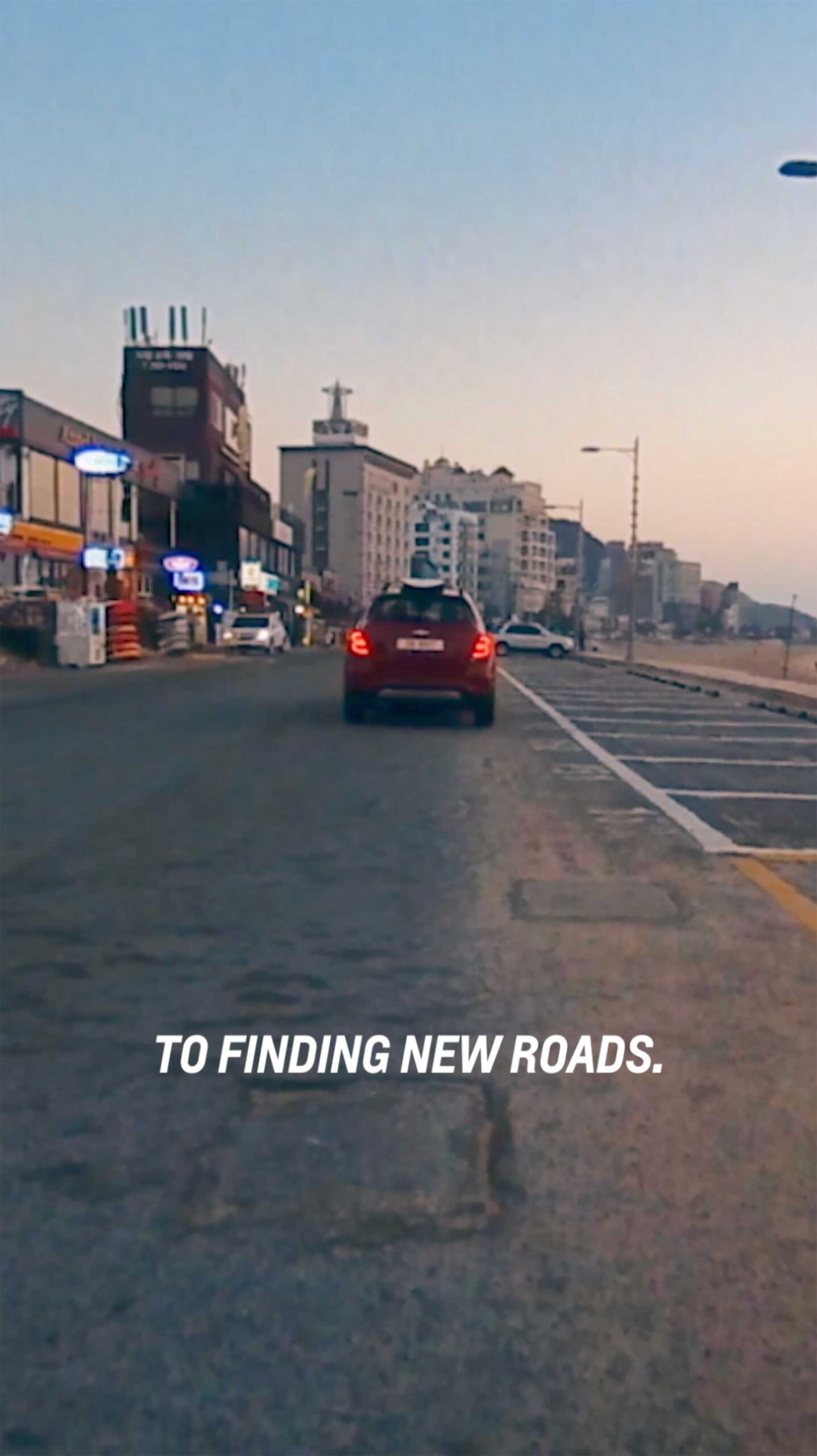 Mihwa drives off in a Chevrolet, surfboard tied to the roof, finding new roads as part of the Chevrolet New Year New Roads campaign.