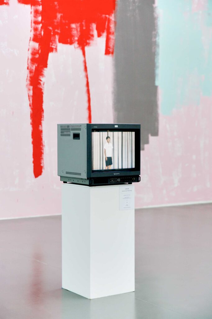 Video art piece on old TV shows young boy in white shirt and dark shorts performing, part of Irony & Idealism exhibition at Gyeonggi Museum of Modern Art, South Korea.