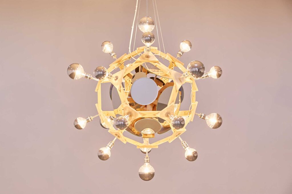 Chandelier-like installation with lightbulbs and mirrors on wooden planet-like construct at Irony & Idealism exhibition, Gyeonggi Museum of Modern Art, South Korea.