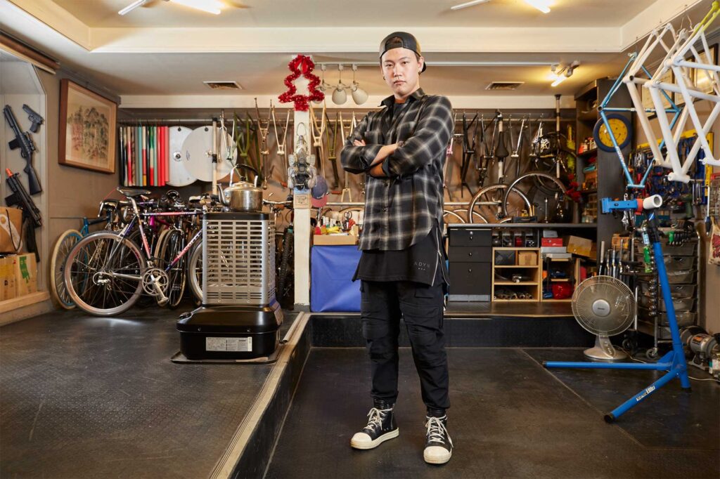 The owner of PUNGNEW bicycle shop in Seoul, South Korea, as he stands in the middle of his store full of custom-built road bike that emphasizes quality and design.