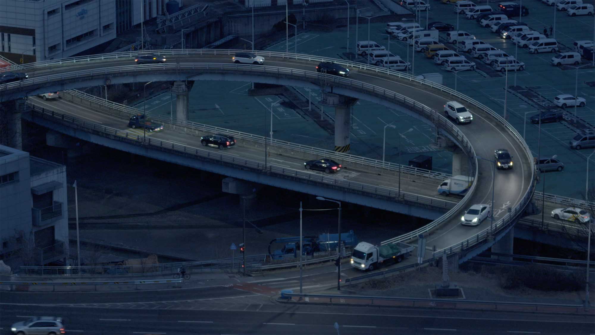 Early morning top view of curved overpass with moving cars in Seoul.