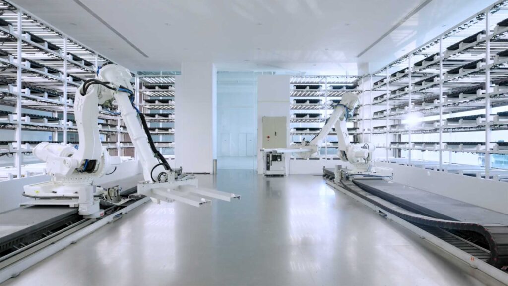 Smart Farm lab interior with robotic arms and vertical grow racks.