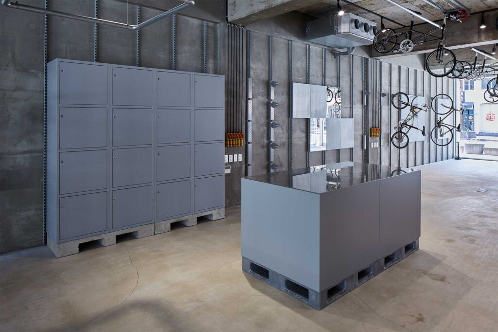 Wide shot of bicycle store on Jejudo with bare concrete, slick grey furniture.
