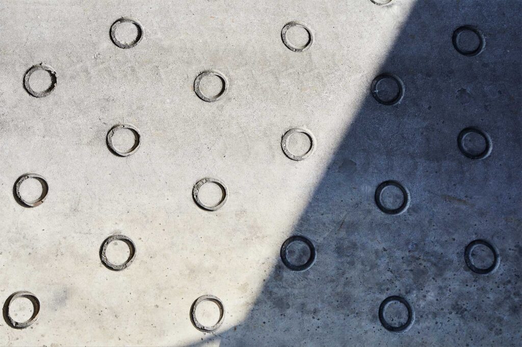 Graphic concrete patterns with hard shadows at logistics site.