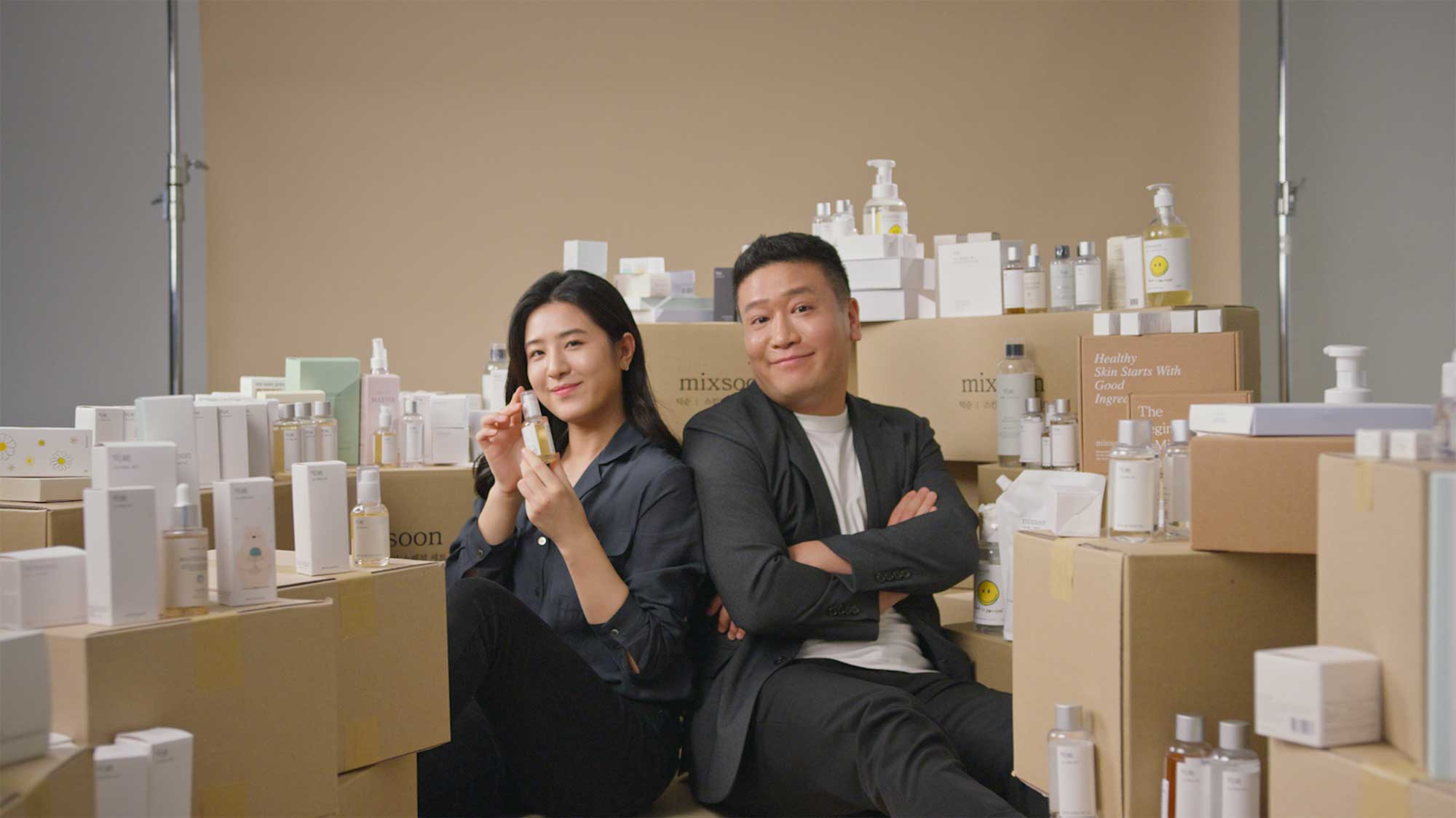 Mixsoon CEO couple with skincare products.