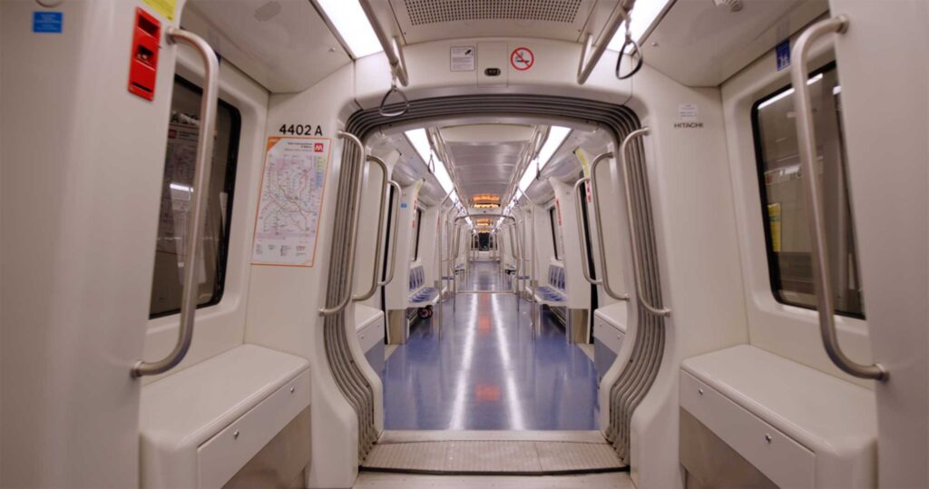 Interior of Milan M4 metro car with clean open layout.