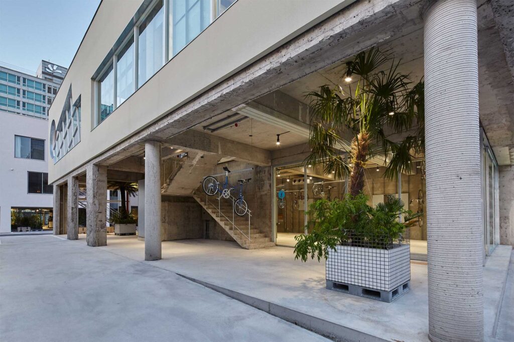 Bicycle store exterior opening behind massive concrete pillars