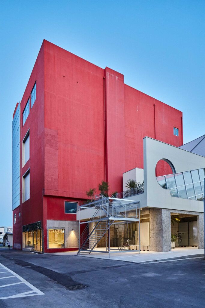 Exterior view of Cream, Freitag, and Bicycle stores connected to Arario museum, red paint shining