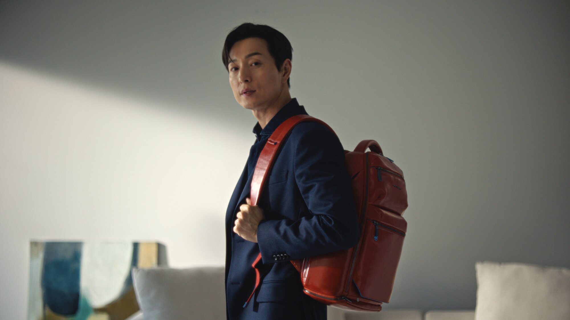 Jung Sung Il portrait wearing Piquadro backpack in modern Seoul setting