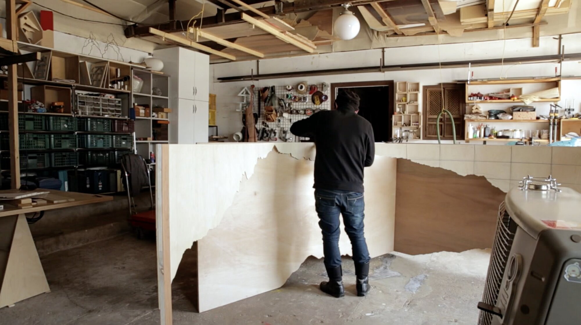 Korean sculpture artist working on wooden installation in workshop for documentary ZDF Wirtschaftswunder Korea