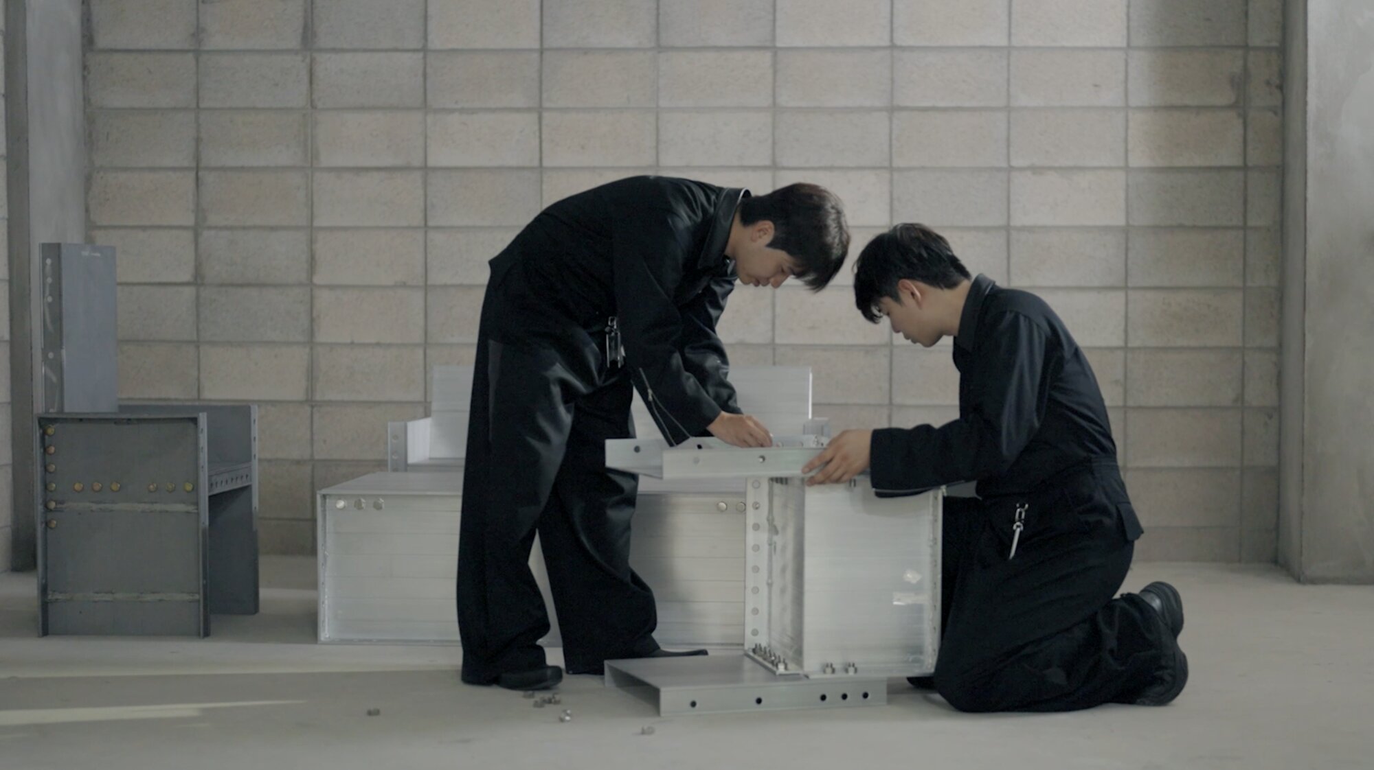 Niceworkshop designers assembling aluminium furniture prototypes.