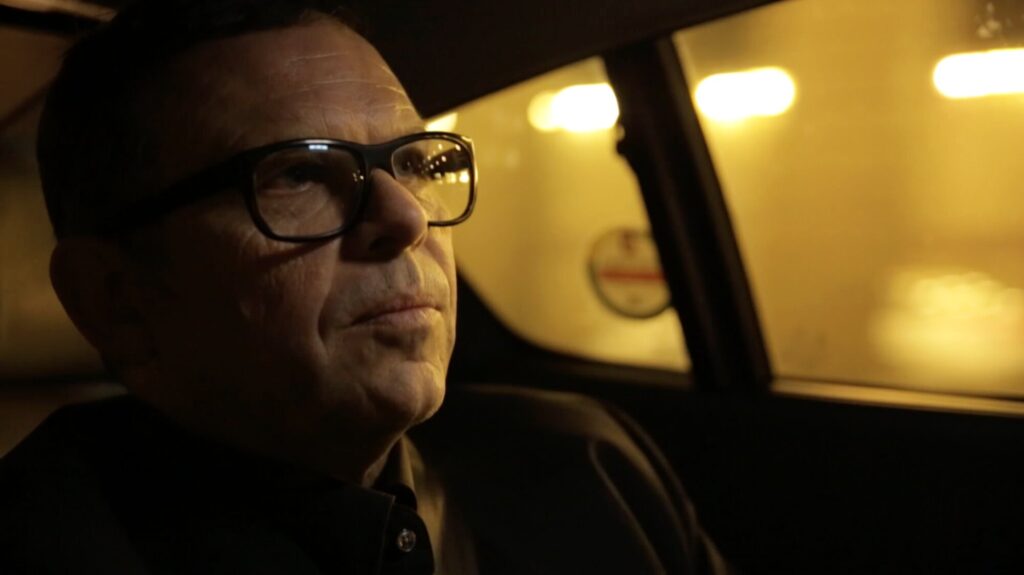 Peter Schreyer in car on way to airport catching flight for documentary ZDF Wirtschaftswunder Korea