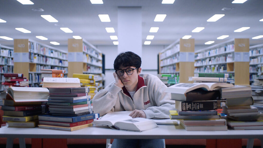 KAIST student studying in library surrounded by books in Daejeon.