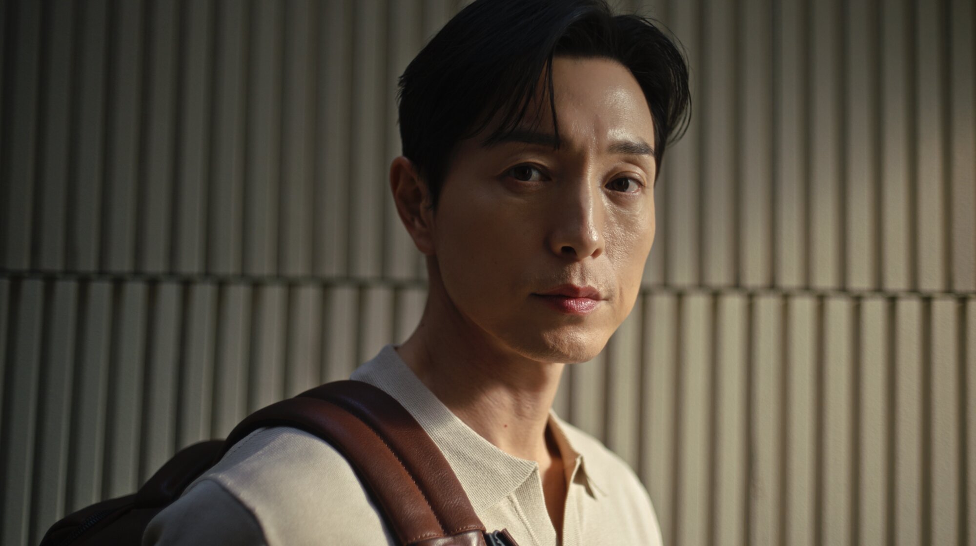 Jung Sung Il portrait wearing Piquadro backpack in Seoul courtyard