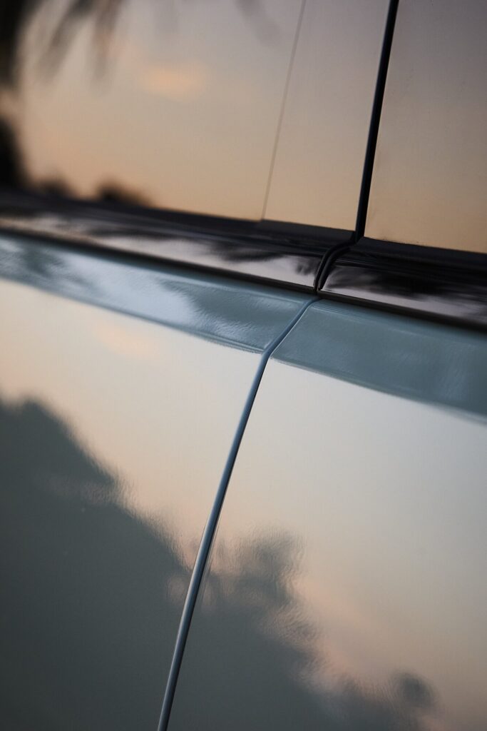 Kia EV3 side panel and window seam showing precise body lines in soft light.