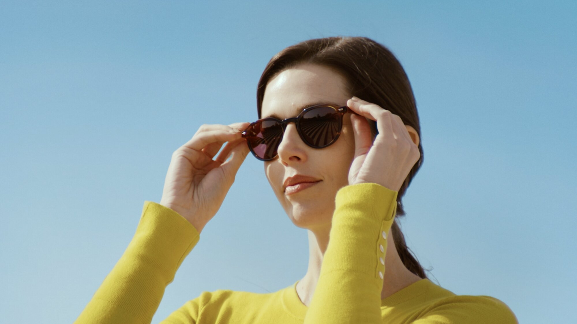 Talent adjusting House of Sun sunglasses under clear sky Seoul