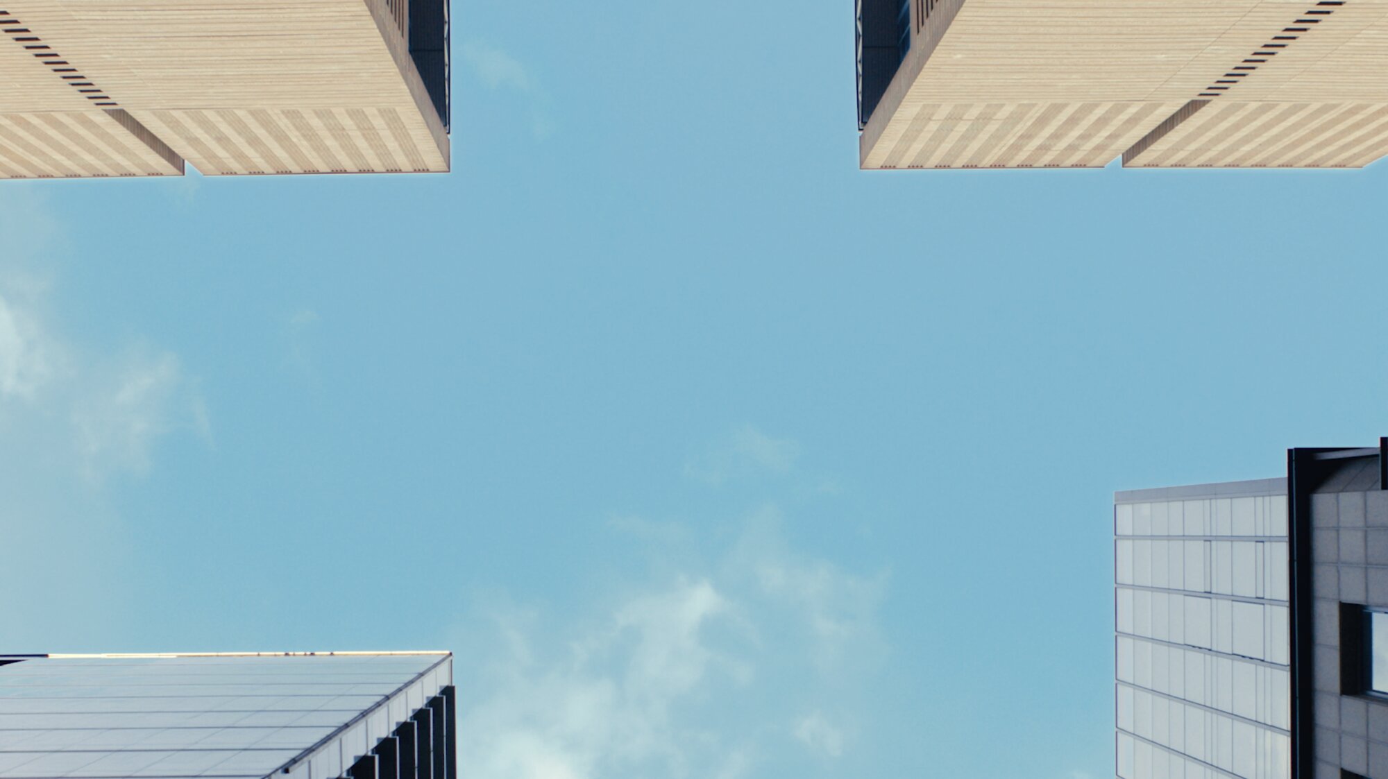 Upward view of office towers and clear sky for ZEISS House of Sun Seoul