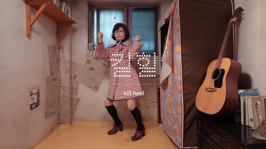 Former factory worker standing in small room wearing work era clothing reflecting resilience identity and everyday gestures shaped by industrial labor