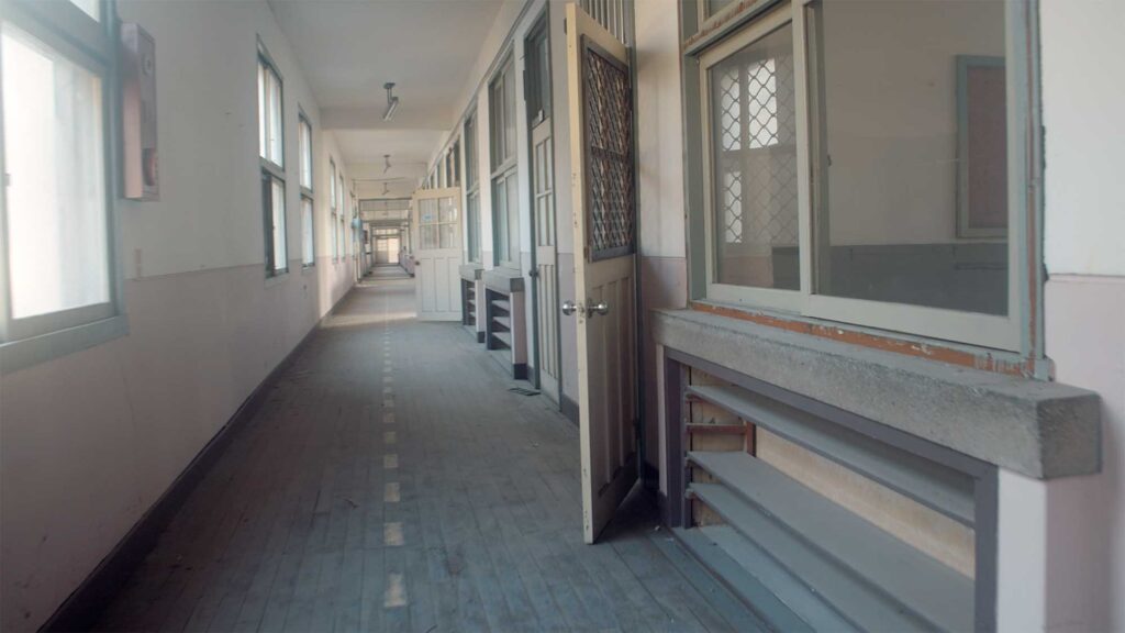 Empty corridor inside former worker housing reflecting institutional architecture and everyday life during Korea’s industrial expansion era
