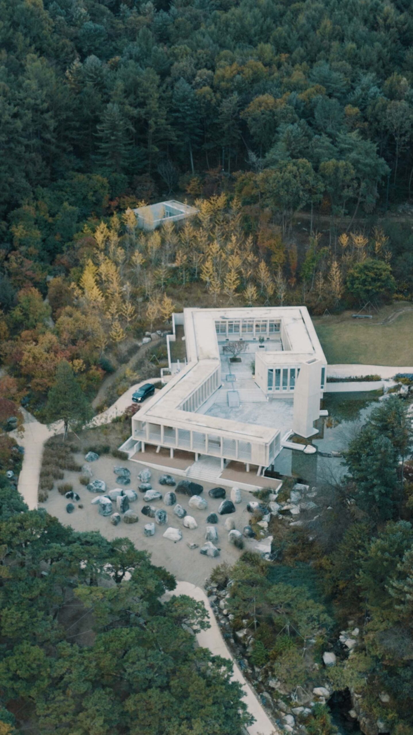 Aerial view of Médongaule architecture surrounded by autumn forest in Yangpyeong