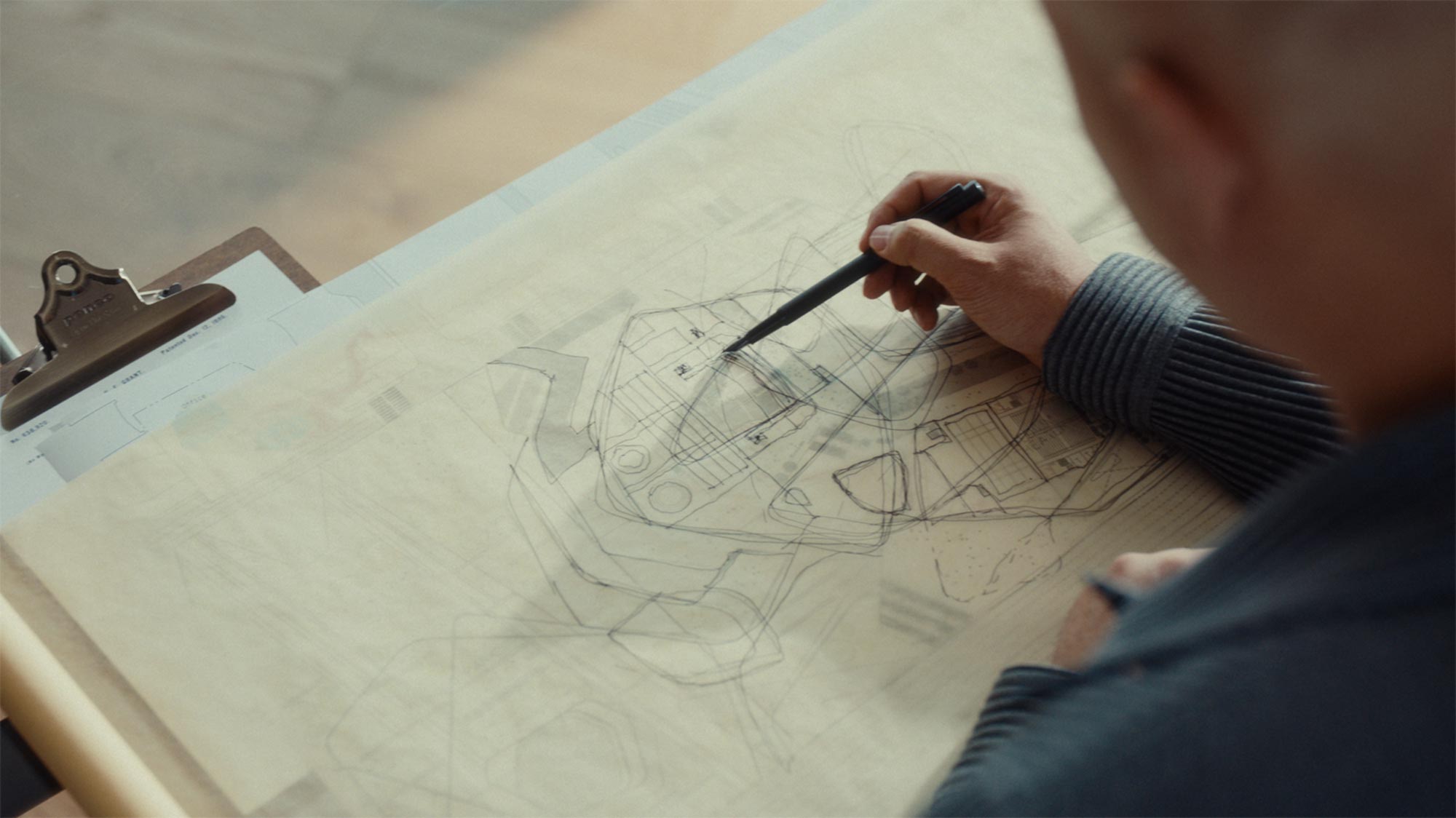 Close-up of Onejae Lee developing architectural design sketches