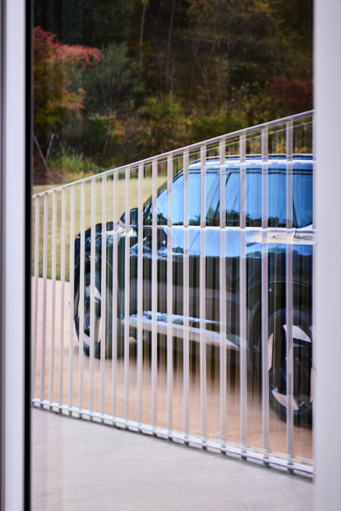 Kia EV5 seen through geometric railing at Médongaule