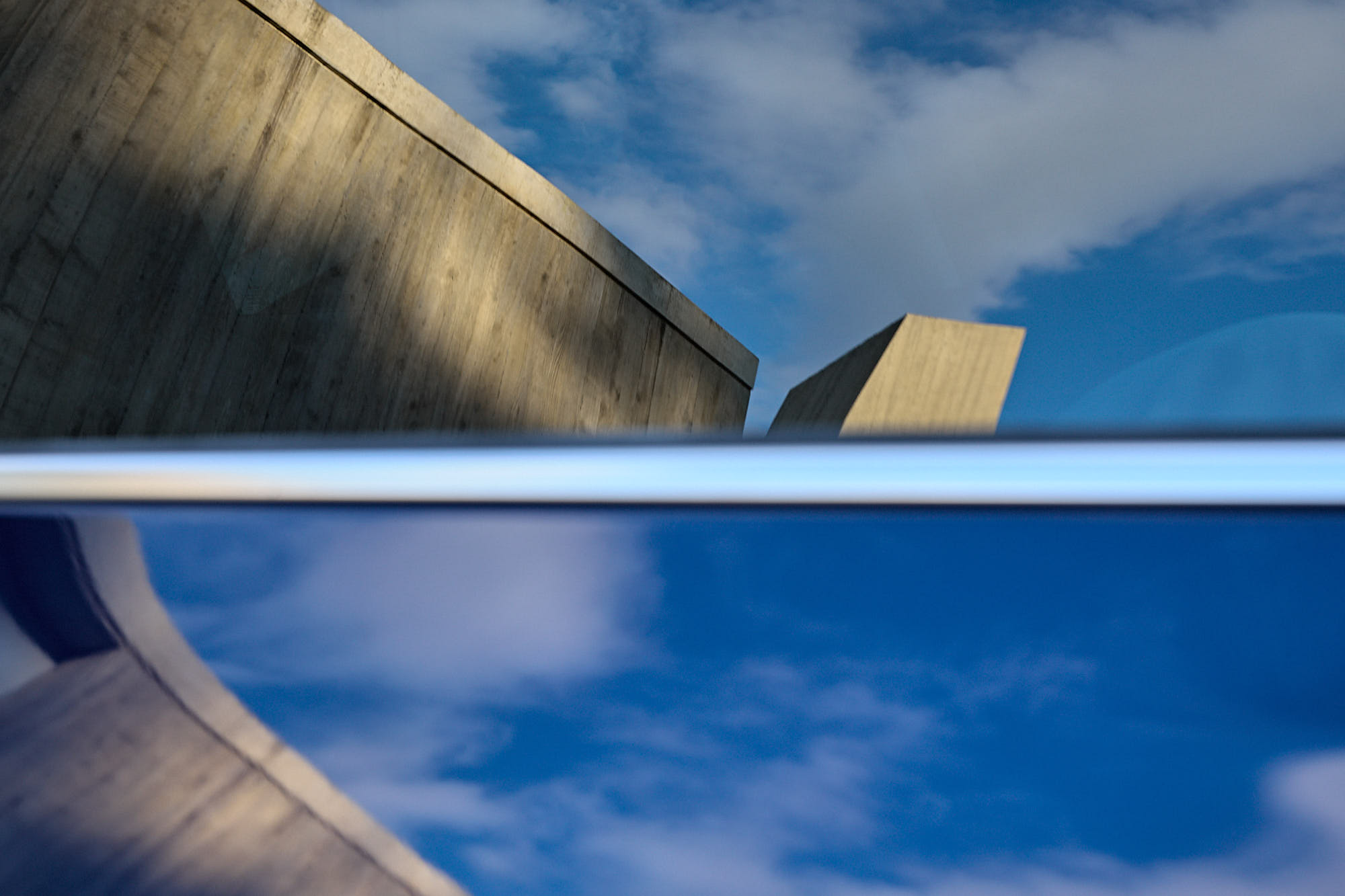 Médongaule architecture and blue sky reflected on Kia EV5 bodywork