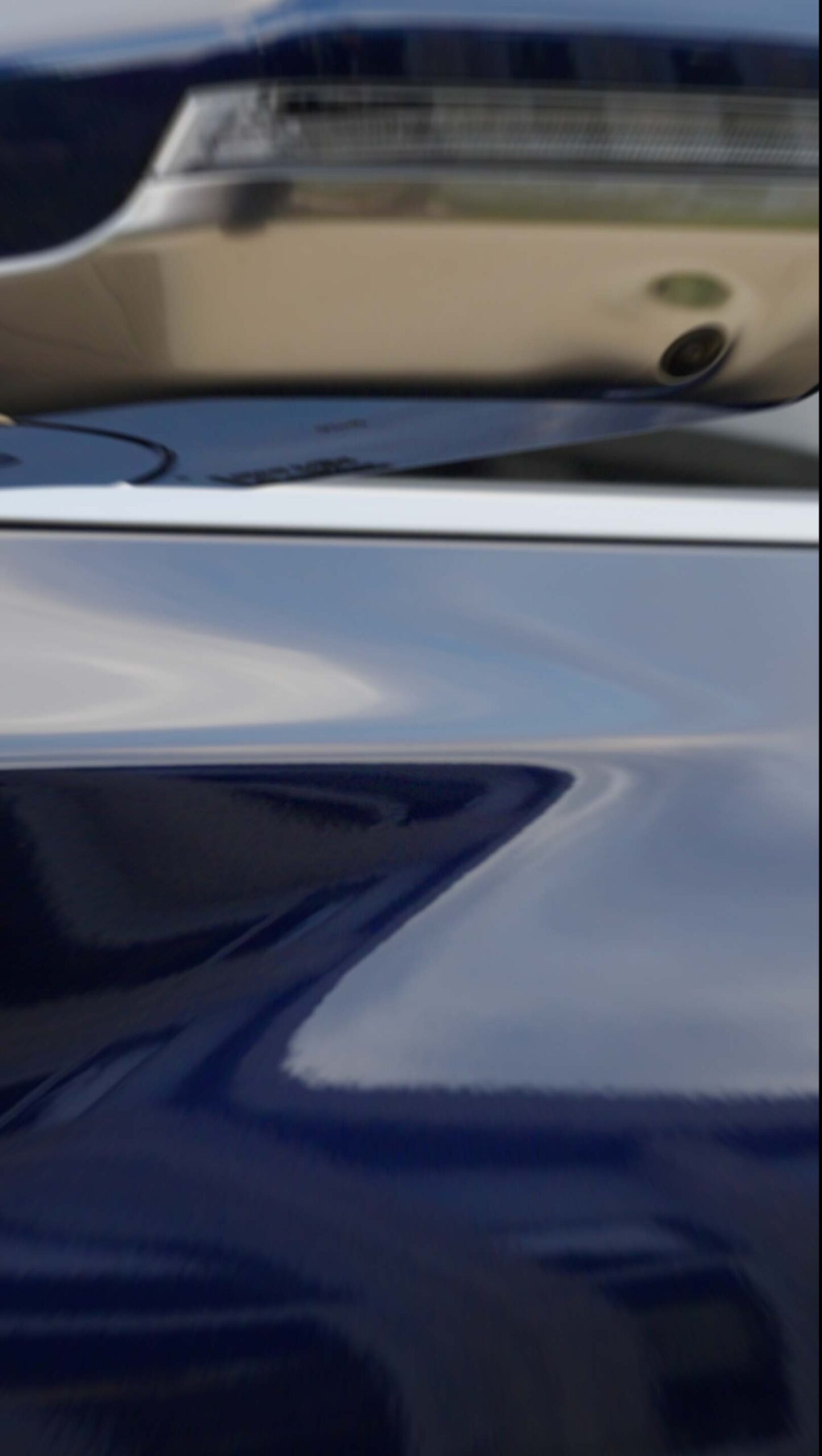 Abstract close-up of Kia EV5 bodywork reflecting the surroundings at Médongaule