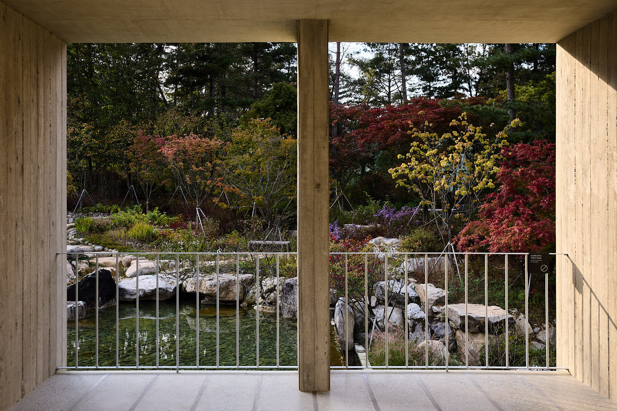 Médongaule concrete colonnade overlooking autumn garden and pond