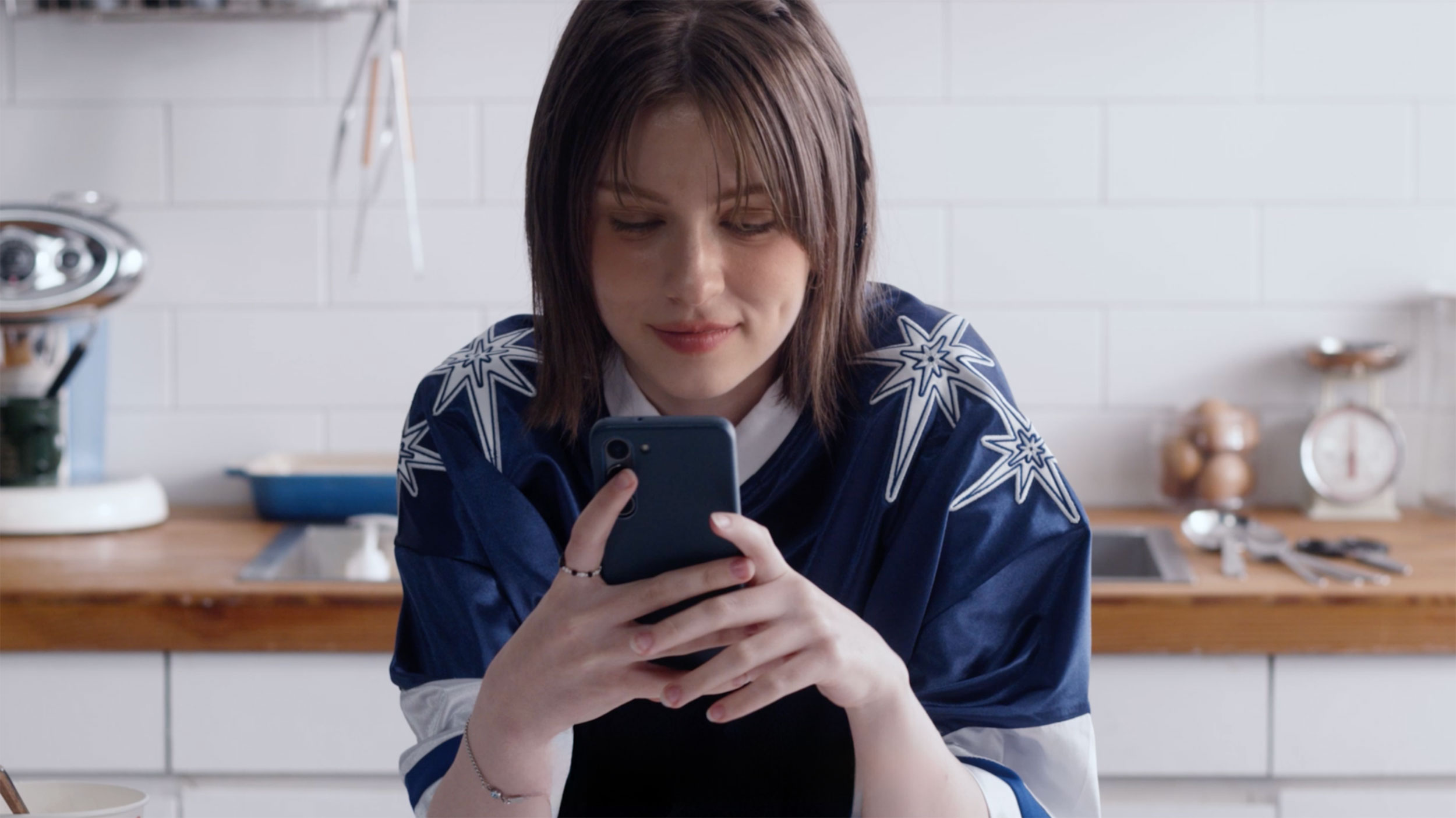 Freya Hawks using the Azar video dating app in a kitchen scene