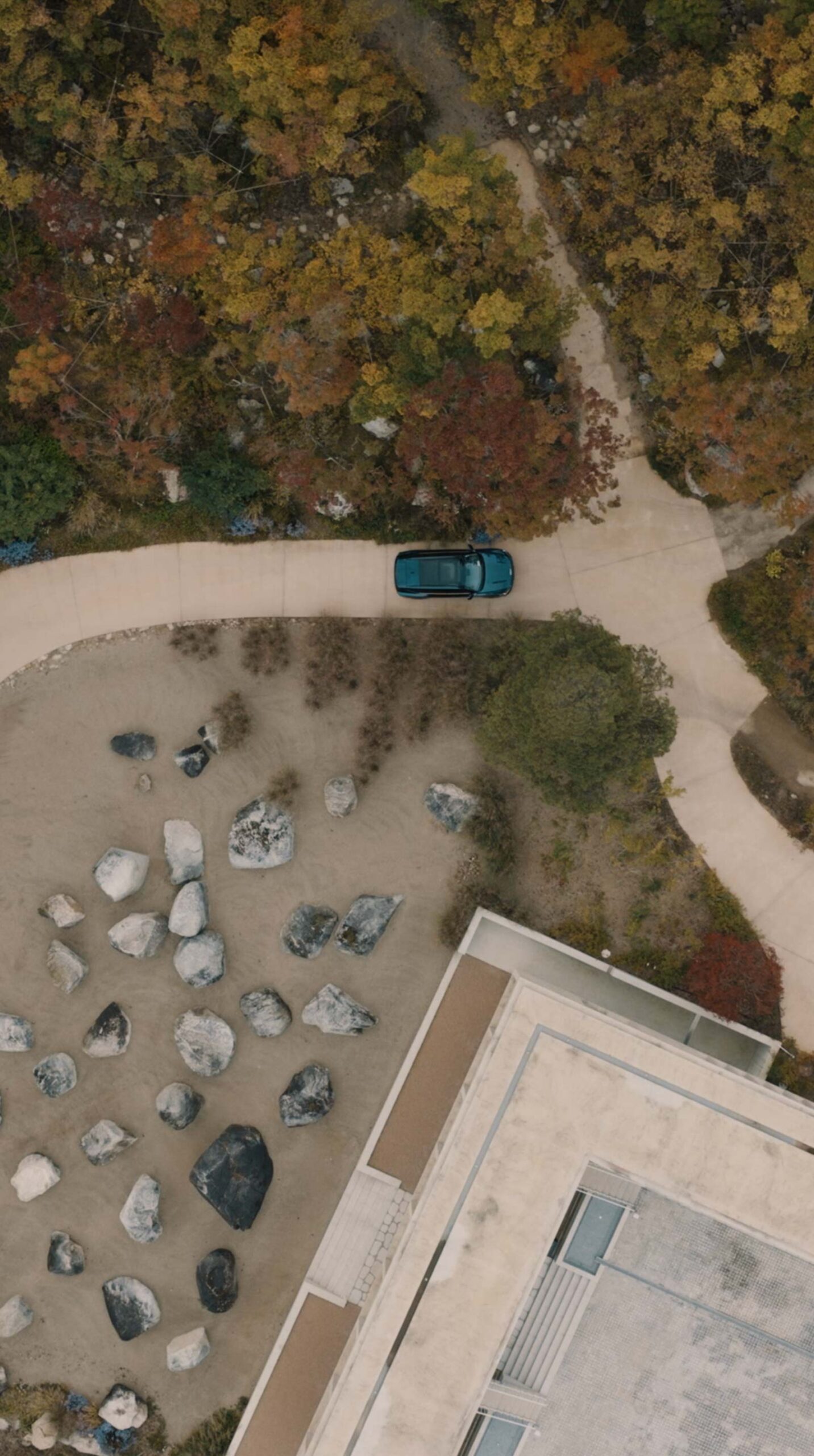 Aerial view of Kia EV5 among Médongaule architecture and autumn gardens