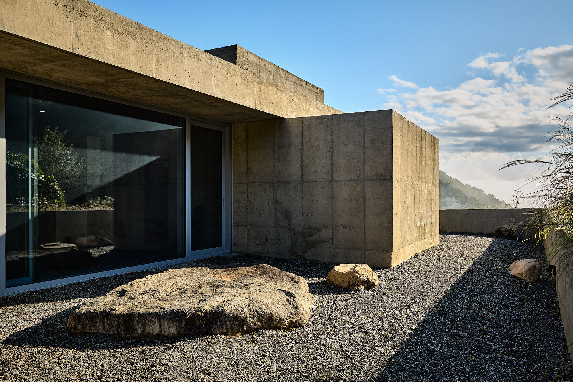 Myök concrete architecture and stone garden in sunlight