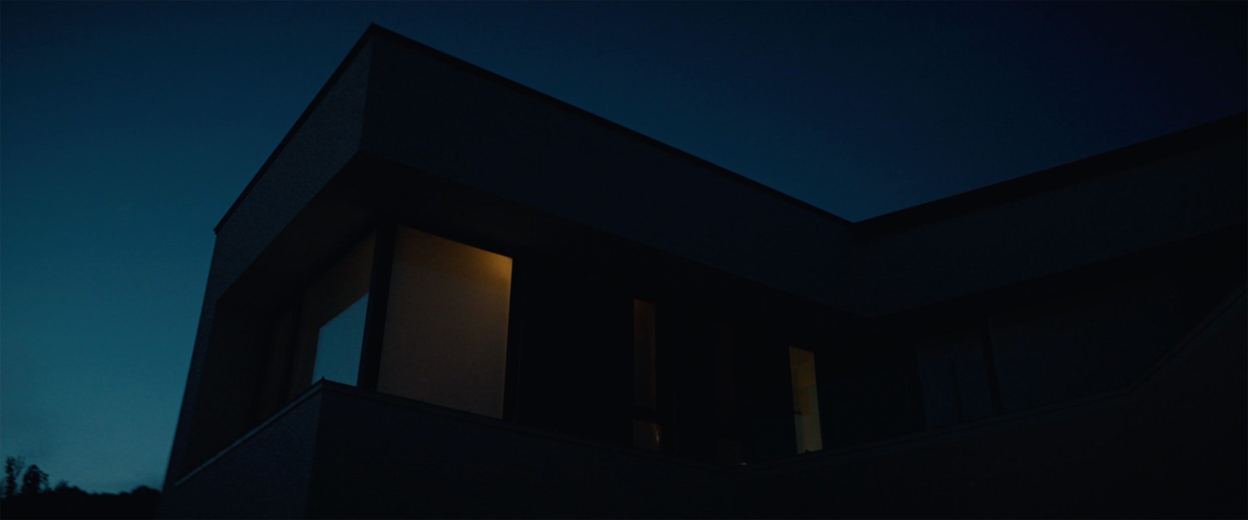 Modern luxury penthouse exterior at night in IDOLS