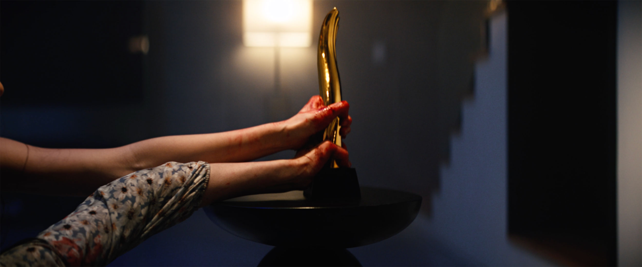 Bloody hands reaching for K-pop idol trophy in IDOLS