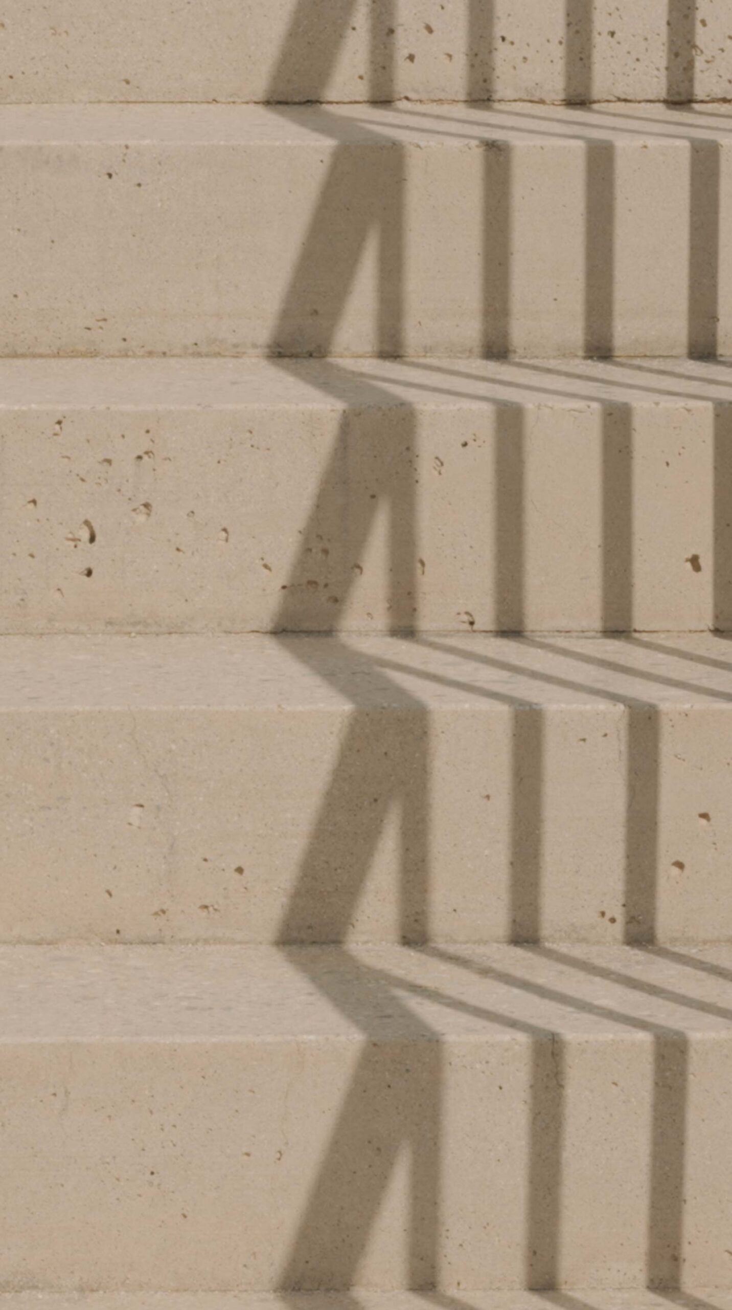Sunlit concrete steps with geometric shadows at Médongaule