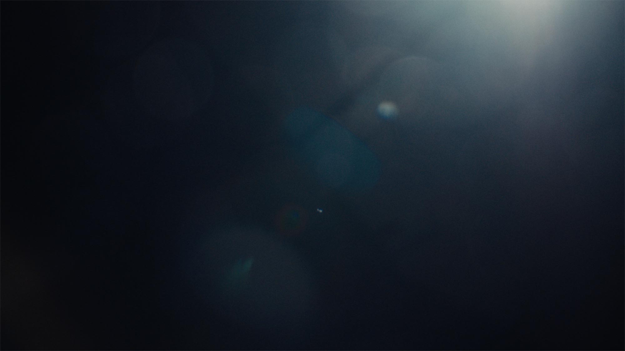 Abstract dark blue light and lens flare transition