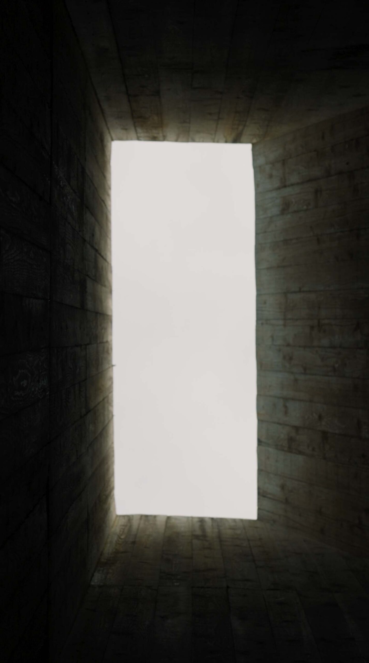 Upward view through monumental concrete architecture at Médongaule
