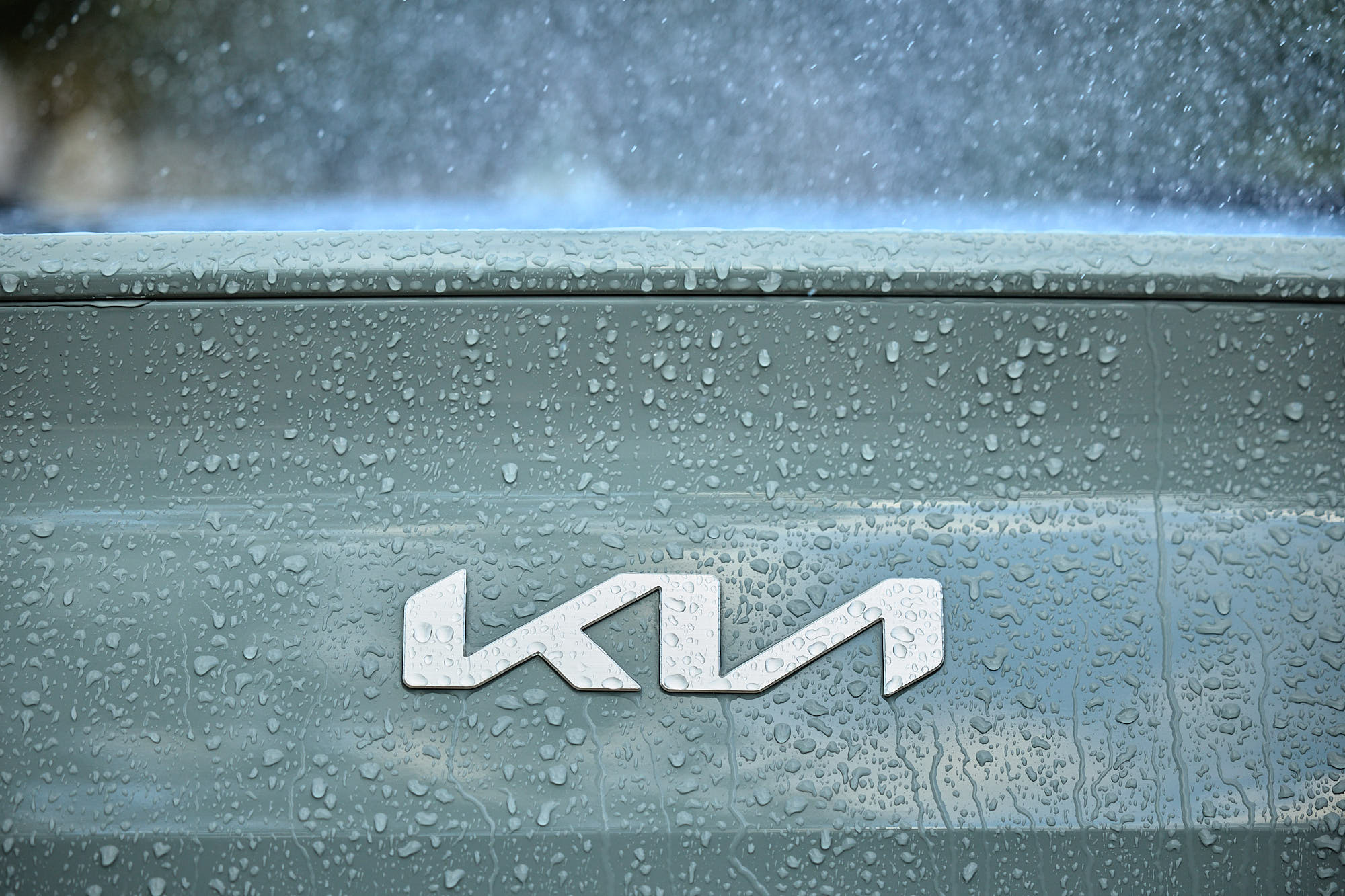 Kia logo and rain droplets on Kia EV4 bodywork