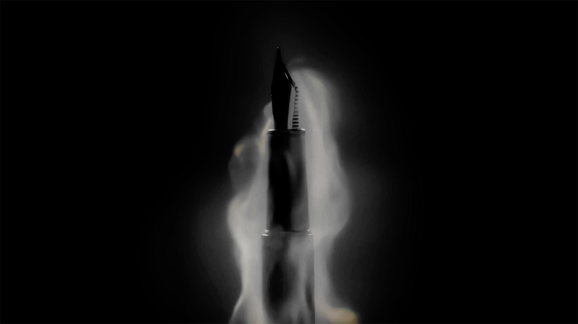 Fountain pen nib with flowing ink in dark studio